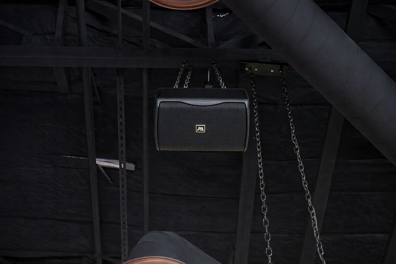 Suspended JBL speaker in industrial venue - Trident-AV